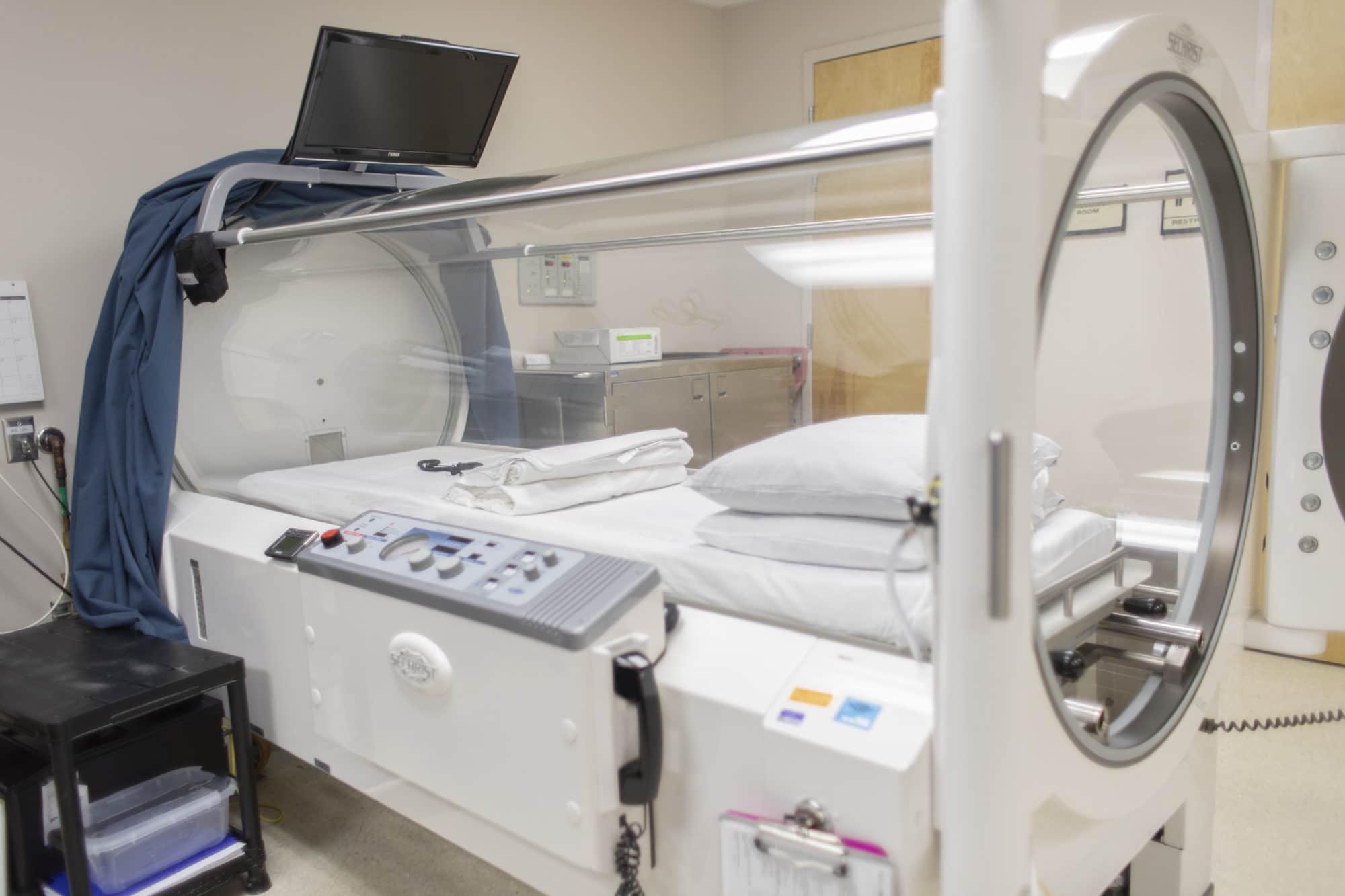 A person inside a hyperbaric oxygen therapy chamber